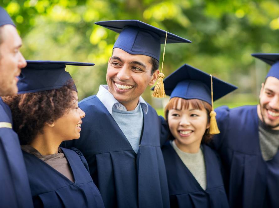 happy students or bachelors in mortar boards