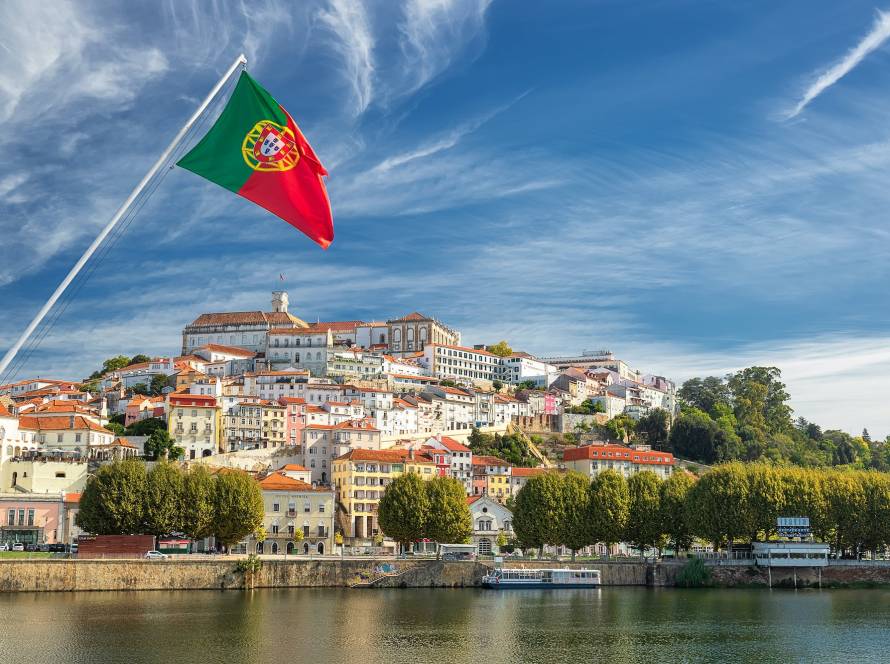 Old university city of Coimbra and the medieval capital of Portugal with Portuguese flag. Europe